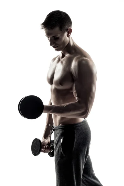 Athletic man showing muscular body and doing exercises with dumbbells — Φωτογραφία Αρχείου