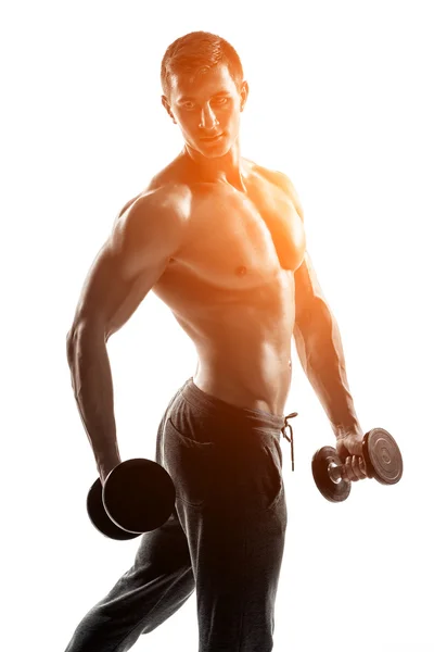 Muscular man showing perfect body with dumbbells, isolated on white — ストック写真