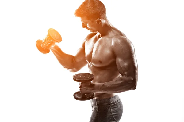 Athletic man showing muscular body and doing exercises with dumbbells — Stok fotoğraf