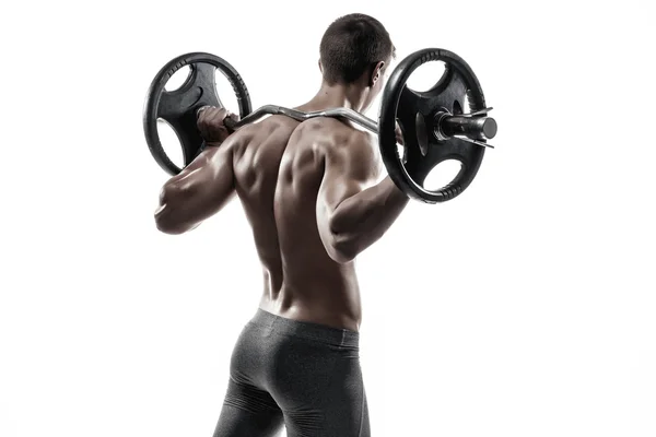 Muscular man holding a barbell on his shoulders, rear view. — Stok fotoğraf