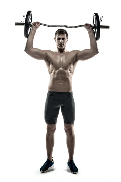 Full length portrait of muscular man exercising with a barbell — Stockfoto