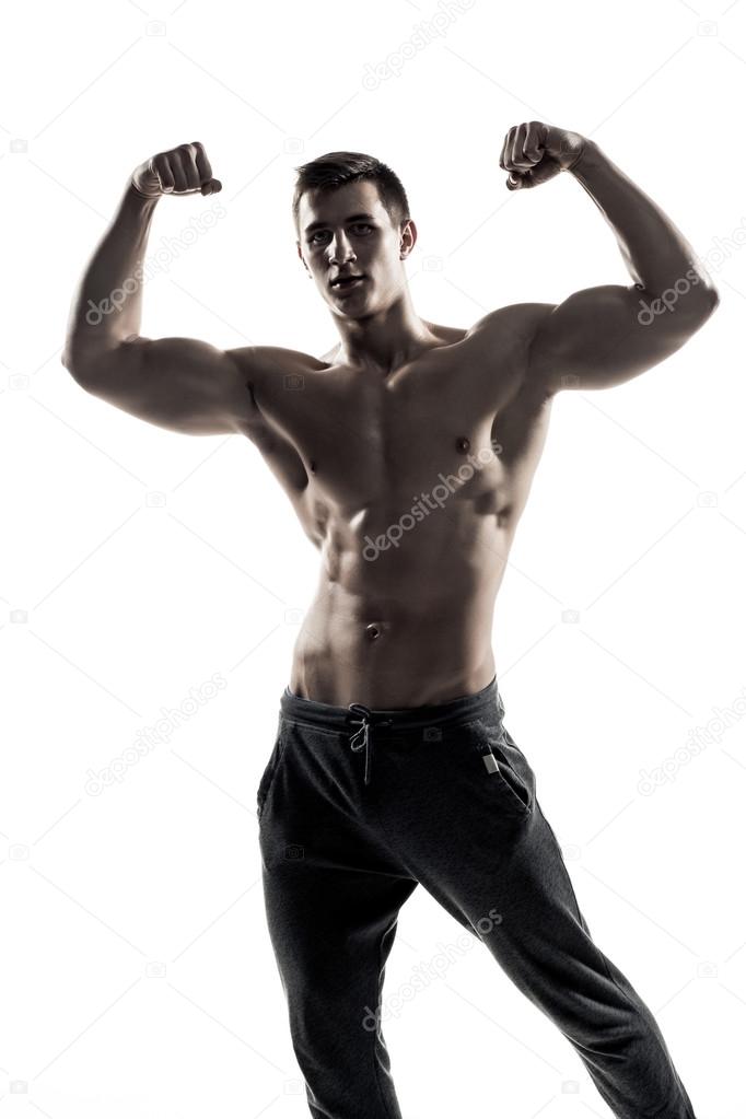Muscular man posing, flexing his biceps, showing perfect body.