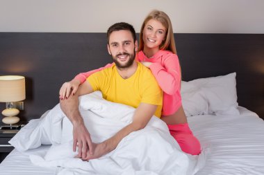 Young lovely couple have fun in a bed