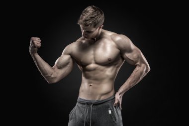 Stunning muscular man showing perfect abs, shoulders, biceps, triceps, chest