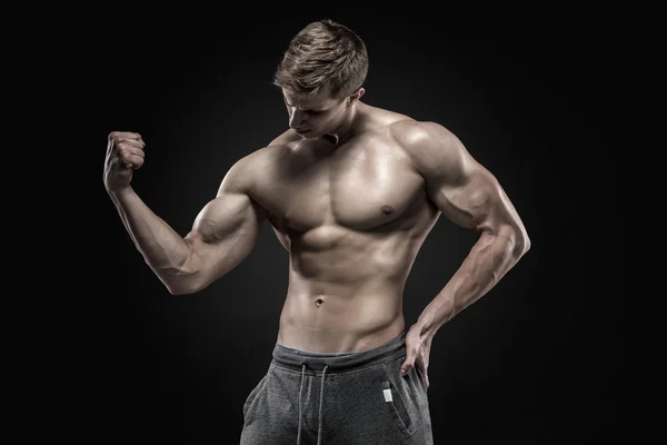 Stunning muscular man showing perfect abs, shoulders, biceps, triceps, chest — Stock Photo, Image