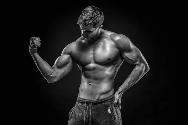 Stunning muscular man showing perfect abs, shoulders, biceps, tr — Stock Photo, Image