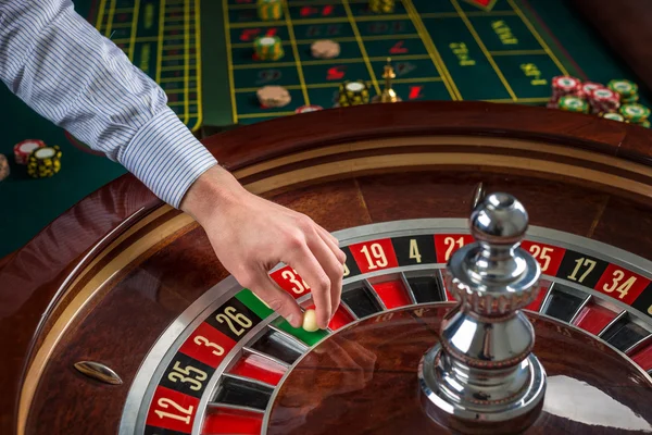 Roulette-Rad und Croupier-Hand mit weißer Kugel im Casino — Stockfoto