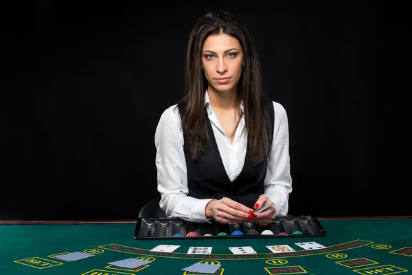 Το όμορφο κορίτσι, έμπορος, πίσω από ένα τραπέζι για το πόκερ — Φωτογραφία Αρχείου
