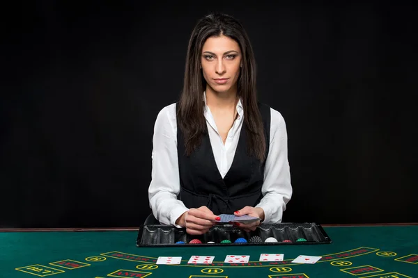 The beautiful girl, dealer, behind a table for poker — Stock Photo, Image