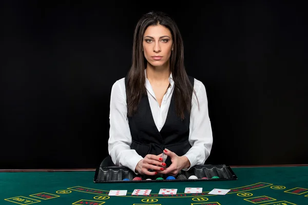 The beautiful girl, dealer, behind a table for poker — Stock Photo, Image