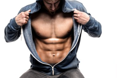 Handsome man with open jacket revealing muscular chest and abs