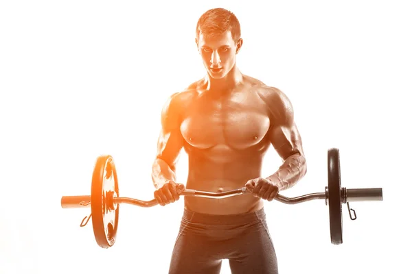 Young handsome man with naked torso and barbell — Stok fotoğraf