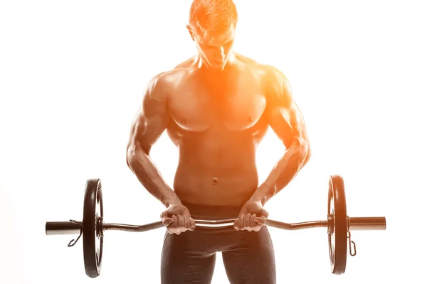 Young handsome man with naked torso and barbell — Stock Photo, Image