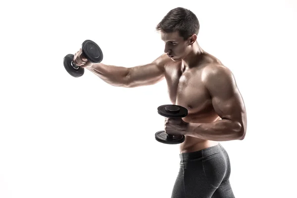 Атлетик показывает мускулистое тело и делает упражнения с гантелями — стоковое фото