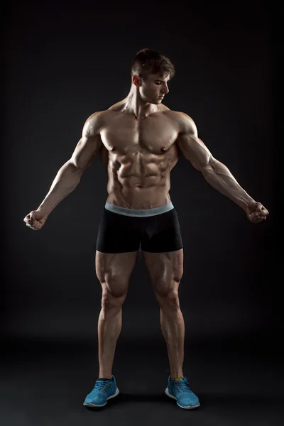 Muscular fisiculturista cara fazendo posar sobre fundo preto — Fotografia de Stock