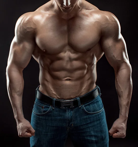 Muscular bodybuilder guy doing posing over black background — Stock Photo, Image