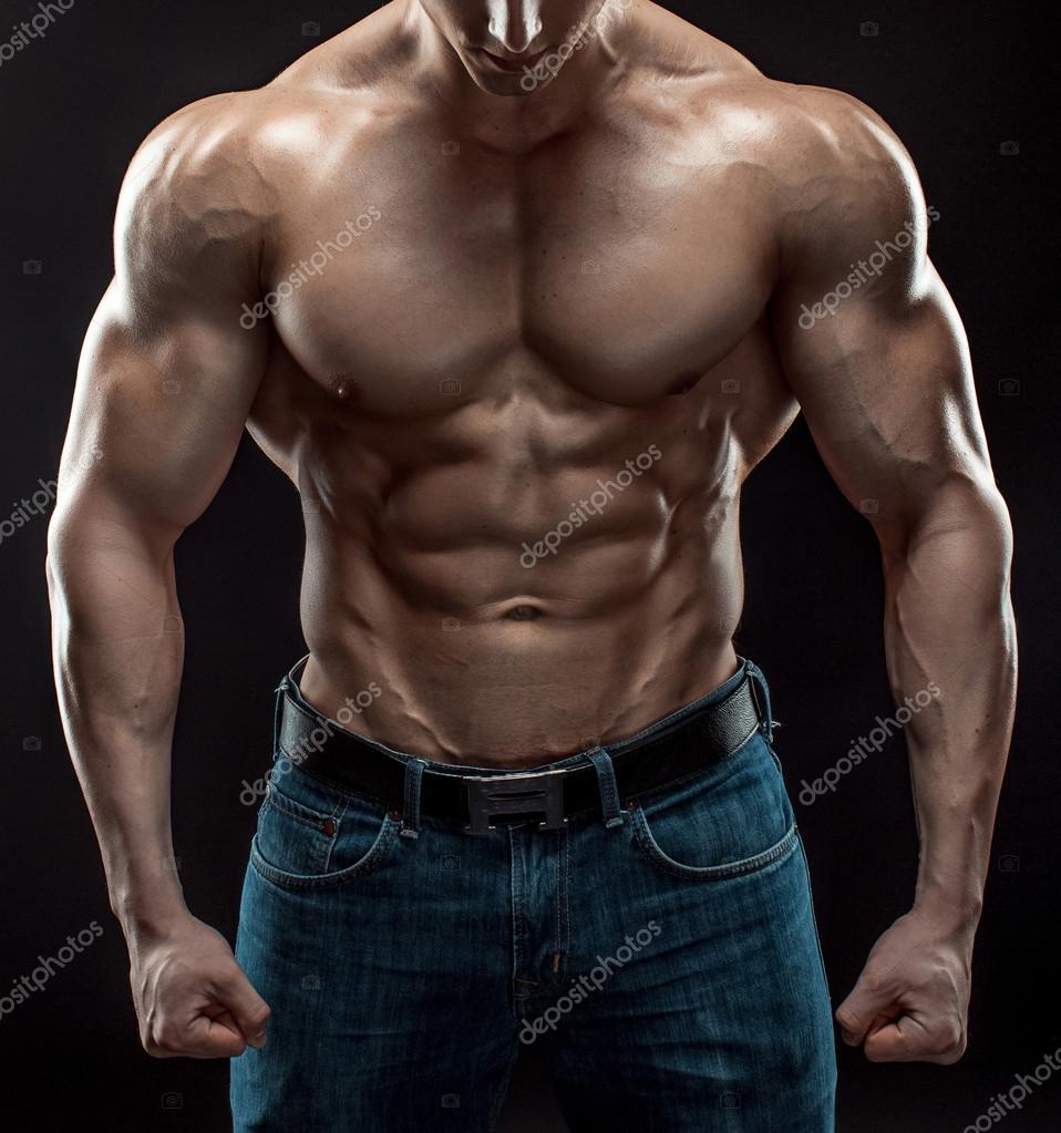 Muscular bodybuilder guy doing posing over black background Stock Photo ...