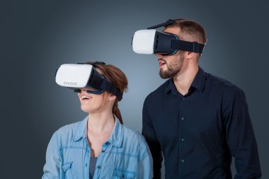 young couple using a VR headset glasses