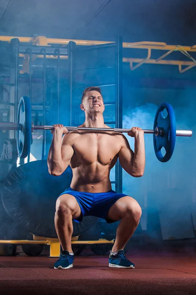 Man doing exercises with barbell — Stock Photo, Image