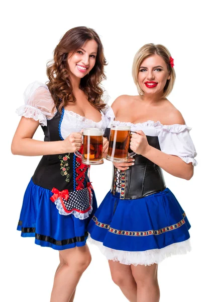 Two beautiful blond and brunette girls of oktoberfest beer stein — Stock Photo, Image