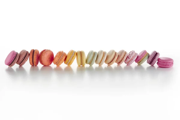 Horizontal line of colorful macarons on white background — Stock Photo, Image