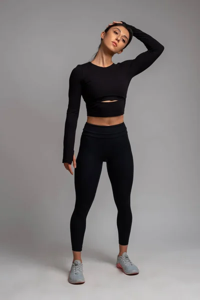 Brunette Girl with a Slim Figure in Leggings Posing in Studio on a Black  Background Stock Image - Image of healthy, business: 159555749