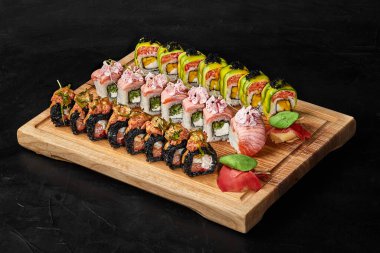 Sushi set of on wooden serving board with gari and wasabi