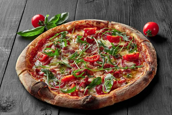 Pizza with pelati sauce, cabanossi, salami, bacon, ham