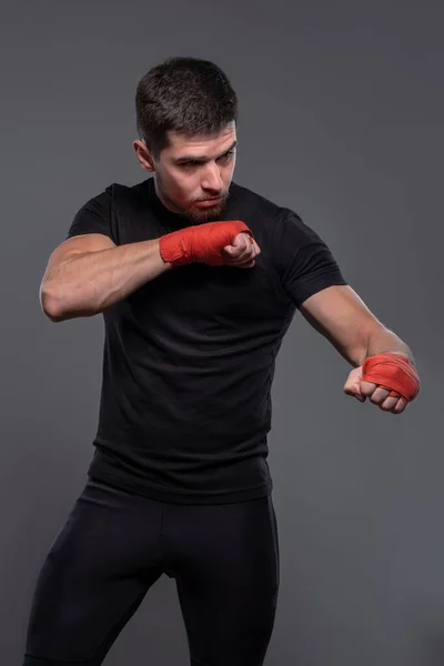 Sportsman with boxing bandages on hands working out defensive techniques — Foto de Stock