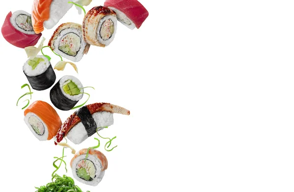 Různé sushi s nakládaným zázvorem a probouzející se vznášející se na bílém pozadí — Stock fotografie