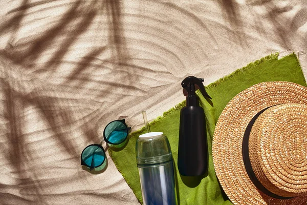 Traveler vacation accessories are laid out on a white beach sand. Flat lay, top view. — Stock Photo, Image