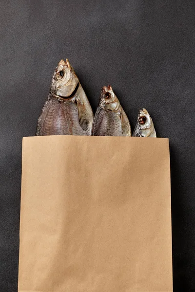 Three salted air-dried fish in kraft paper packaging bag
