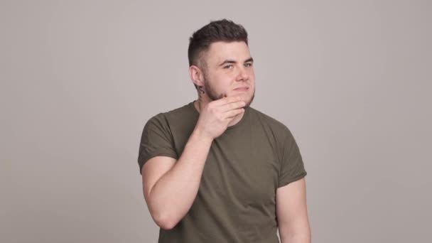 Worried young bearded man examining his face skin — Stock Video