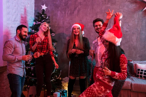 Young people with glasses of champagne at Christmas party