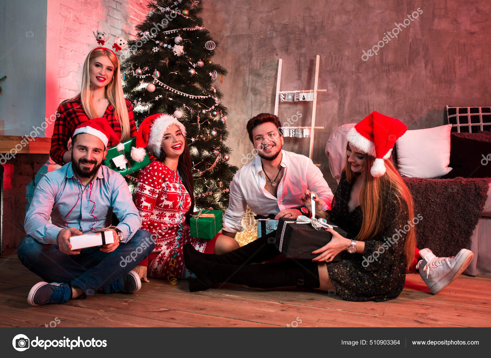 Grupo De Jovens Amigos Alegres Sentados Por Uma Árvore De Natal
