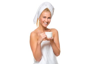 Young attractive woman in towel holding a cup