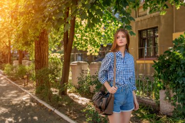Portrait of a beautiful young woman on the streets city