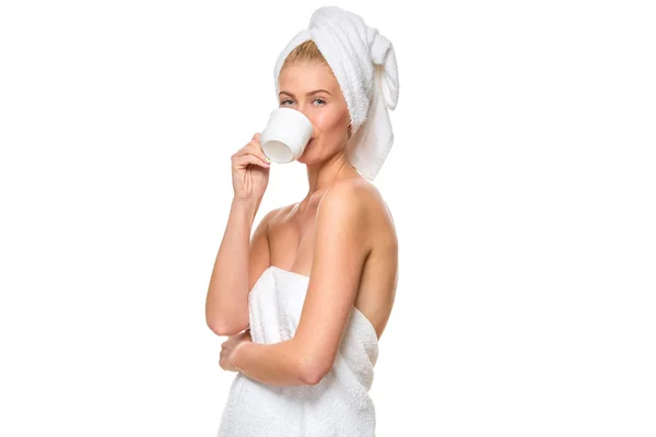 Young attractive woman with blue eyes in towel drinks — Stock Photo, Image