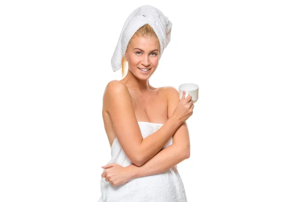 Young attractive woman in towel holding a cup — Stock Photo, Image