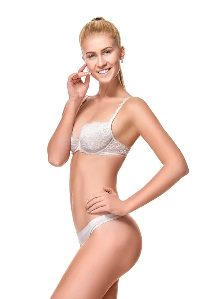 Young blonde woman wearing white underwear isolated over light b — 스톡 사진
