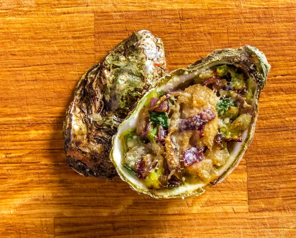 Salad in oyster on a wooden background. — Stock Fotó