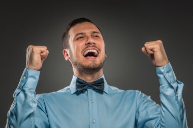 Portrait excited, happy man, arms up fists pumped celebrating su