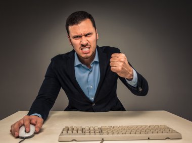 Portrait angry upset young man in blue shirt and jacket