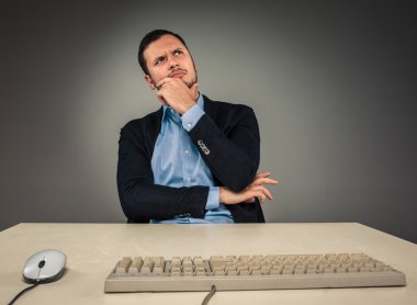 Handsome man sitting at a desk and looking up