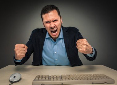Portrait angry upset young man in blue shirt and jacket