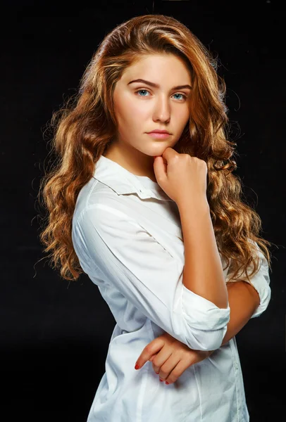 Portrait beautiful young brunette woman with wavy hair in white — Stockfoto