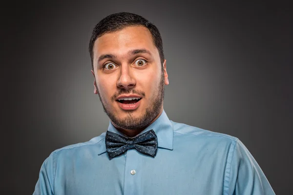 Portrait young man in blue shirt, looking with amazement — ストック写真