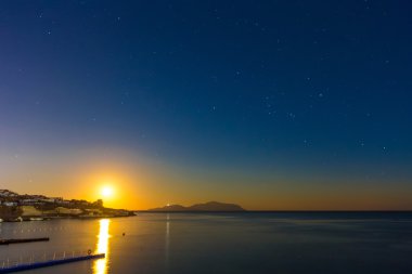 Landscape with beautiful sunset and dark sky over Red sea