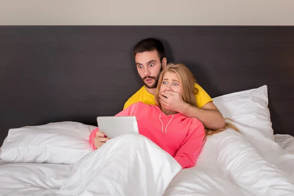 Young Sweet Couple at Bed Watching Something on Tablet Gadget — Stock Fotó