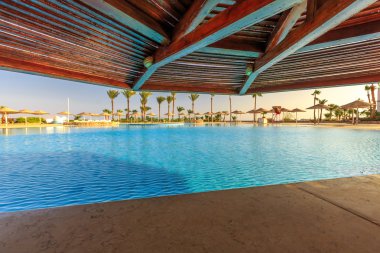Looking up umbrellas with view at swimming pool in Egypt